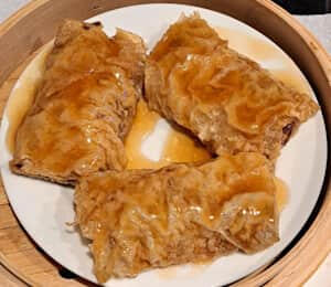 H06. Bean Curd Skin Roll $11.00 Steamed bean curd skin rolls with a napa cabbage, carrot, shiitake mushroom, shallot, and dry tofu filling