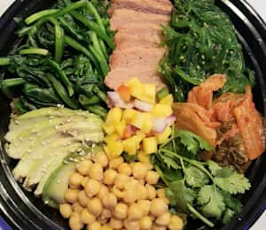 Bibimbap $20.00 Korean-style rice bowl with seitan, avocado, green seaweed, chickpeas, spinach, mango salsa, cilantro, and kimchi. Served with sesame peanut sauce and chili sauce.