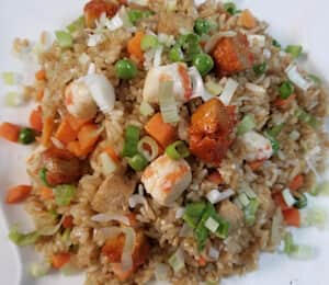 Yangzhou Fried Rice $20.00 Chinese style fried rice with vegan chicken, vegan shrimp, vegan char siu, peas, carrots, and lettuce.