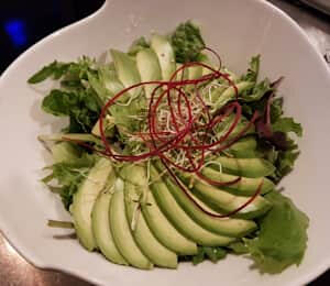 12. Avocado Salad $12.00 Mixed greens with avocado slices and shredded carrots. It comes with a vegan Thousand Island or carrot-ginger sauce.