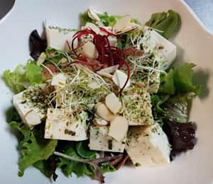 09. Tofu Salad $11.00 Tofu and mixed greens are topped with dried seaweed, sesame seeds, and almonds. It comes with carrot-ginger dressing.