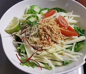15. Green Papaya Salad $12.00 Green papaya, tomatoes, peppers, and mixed greens with a plum dressing, topped with crushed peanuts and a lime wedge
