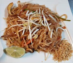 09. Pad Thai (Spicy) $17.00 Thai-style stir-fried thin rice noodles with dry tofu, bean sprouts, bell peppers, and onions topped with crushed peanuts and lime