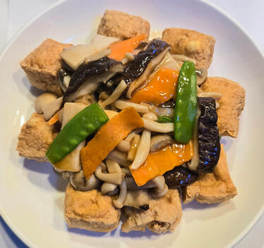 Braised Mixed Mushrooms Over Tofu $19.00 Braised assorted mushrooms, carrots, and snow peas over a bed of fried or silken tofu