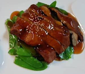 D13. Smoked Vegan Duck $20.00 Sautéed slices of smoked seitan in a house special sauce on a bed of snow peas