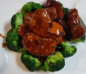 D18. Orange Vegan Beef (Spicy) $20.00 Sautéed breaded medallions of seitan in a spicy citrus sauce on a bed of broccoli