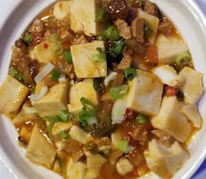 D22. Mapo Tofu (Spicy) $19.00 Spicy sichuan-style silken tofu with diced bell peppers, spicy preserved radish, seitan, shiitake mushrooms, peas, and carrots, topped with scallion